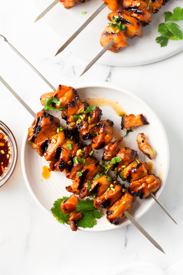 Hot Honey Chicken Skewers sprinkled with cilantro. 