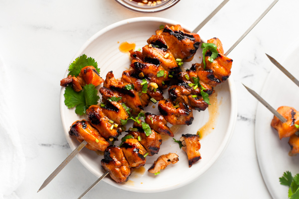Hot Honey Chicken Skewers on a white plate. 