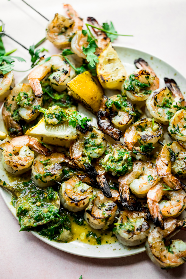 Chimichurri Grilled Shrimp Skewers topped with extra sauce. 