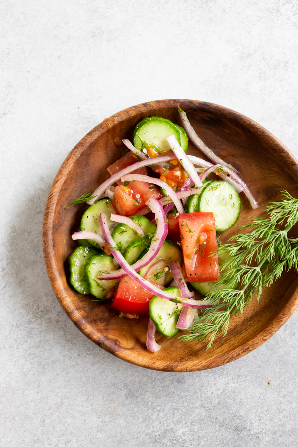 Cucumber Tomato Salad on a wooden plate. 