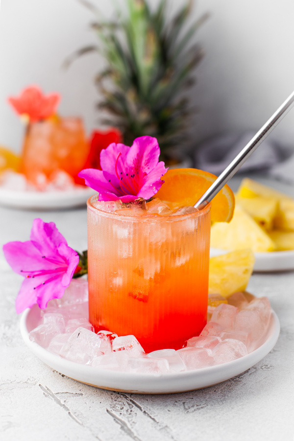 Pineapple Rum Punch served with ice and a straw. 