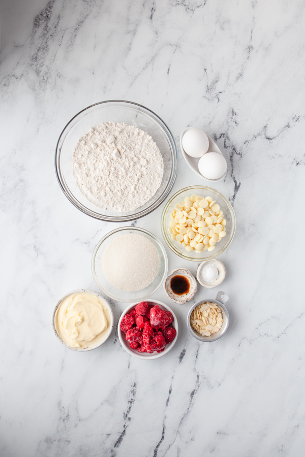 Ingredients to make White chocolate berry blondies  on a table. 