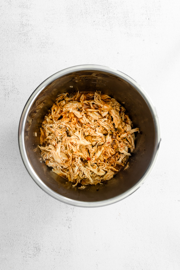 Shredded Instant Pot chicken in a container. 