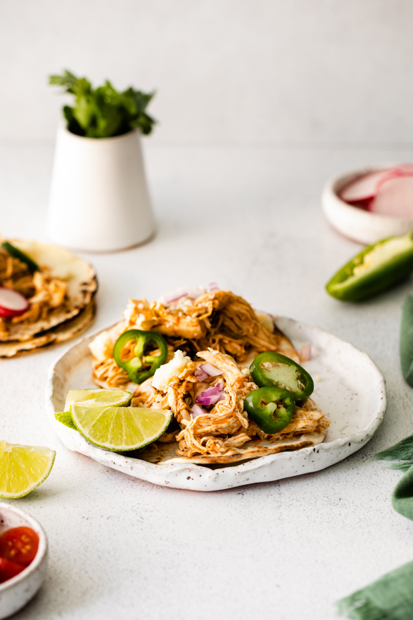 Instant Pot Pulled Chicken Tacos served with fresh limes. 