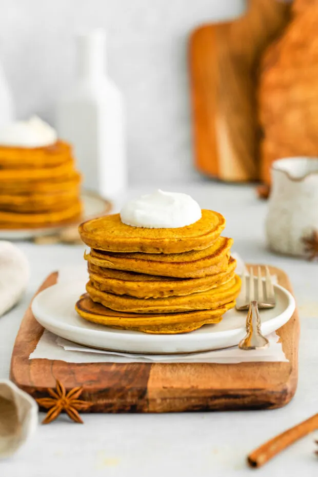 Pumpkin pancakes topped with whipped cream. 