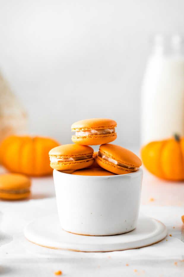 Pumpkin Spice Macarons placed in a bowl. 