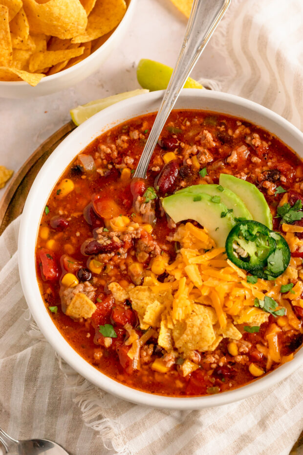 Slow Cooker Taco Soup topped with avocado.