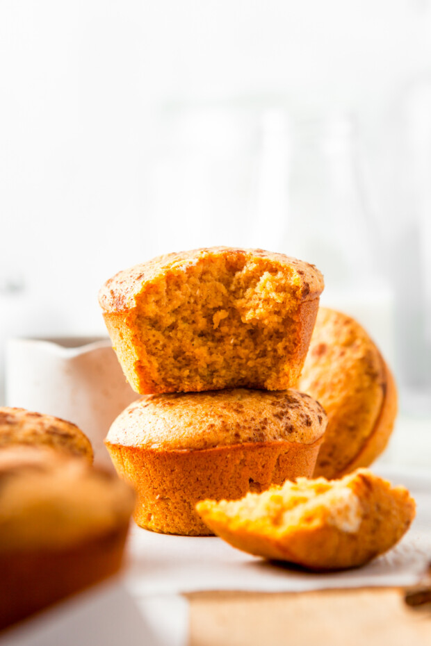 Sweet Pumpkin Cornbread Muffins stacked up on each other. 