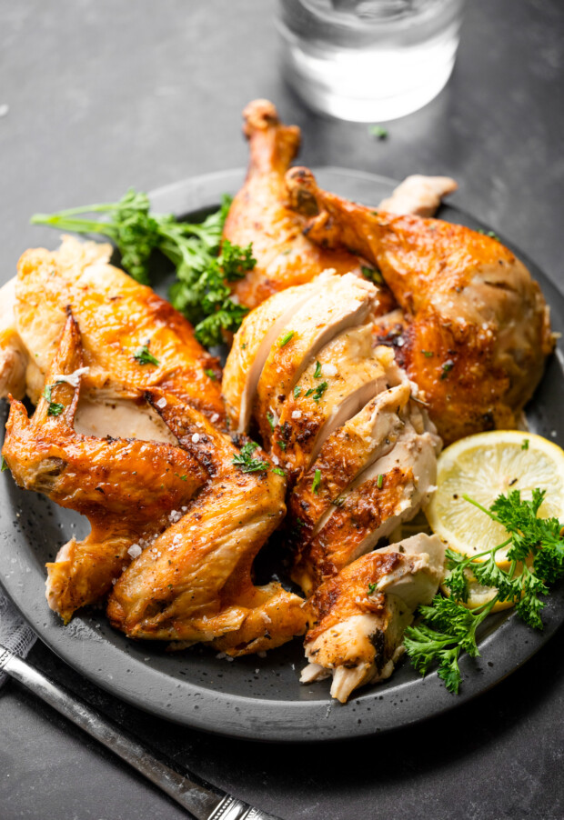 Air Fryer Whole Chicken served with lemon. 