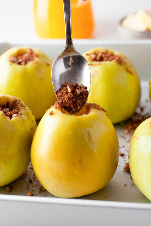 Cinnamon Baked Apples being filled with cinnamon and sugar. 