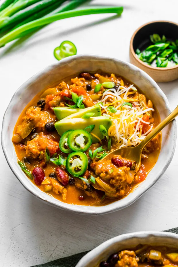 Turkey Pumpkin Chili in a bowl with a spoon.