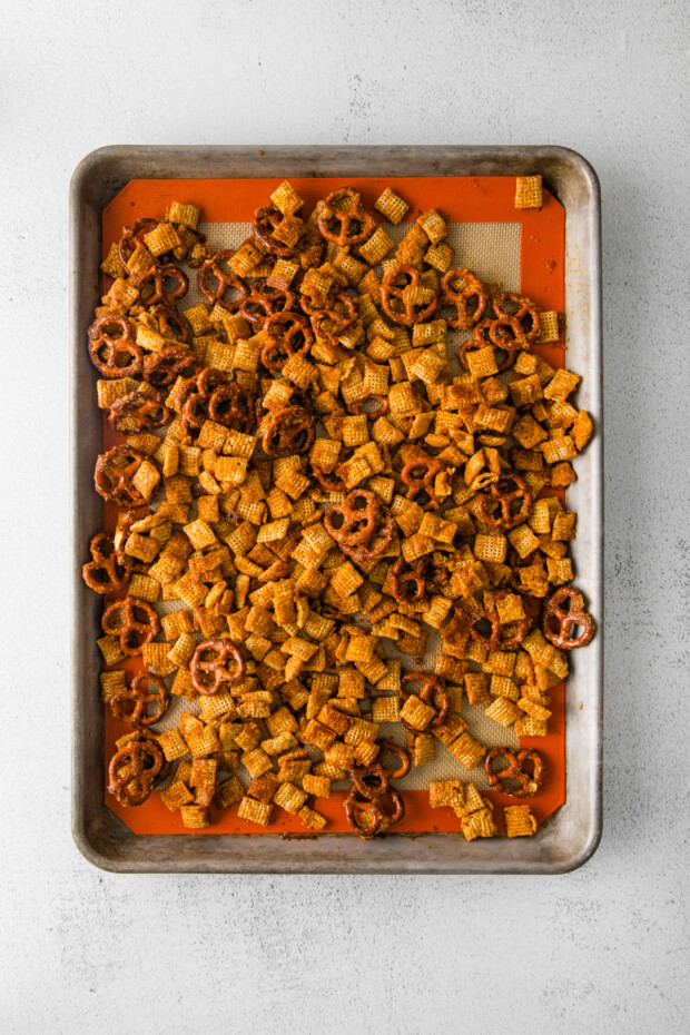 Harvest Chex Mix on a sheet pan waiting to get baked. 