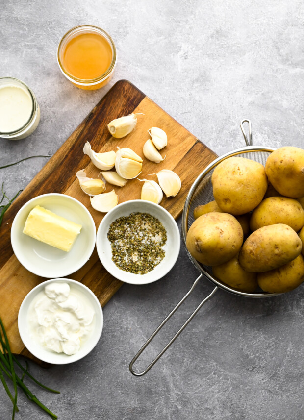 Ingredients to make Instant Pot Mashed Potatoes on a table. 