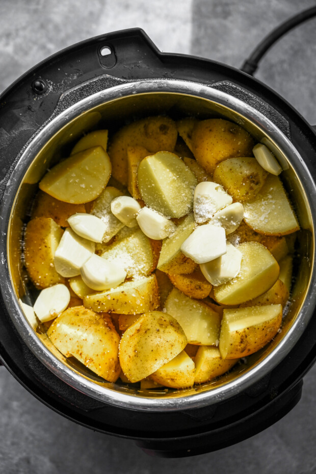 Chopped potatoes and garlic in the Instant Pot. 