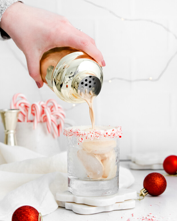 Pouring Peppermint White Russian into a cocktail class. 