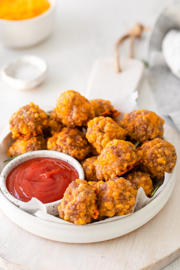 Sausage Cheese Balls served in a bowl with ketchup. 