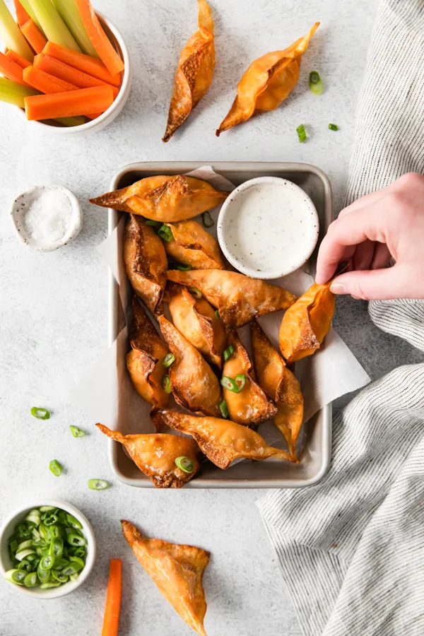 Air Fryer Buffalo Chicken Wontons being picked up. 
