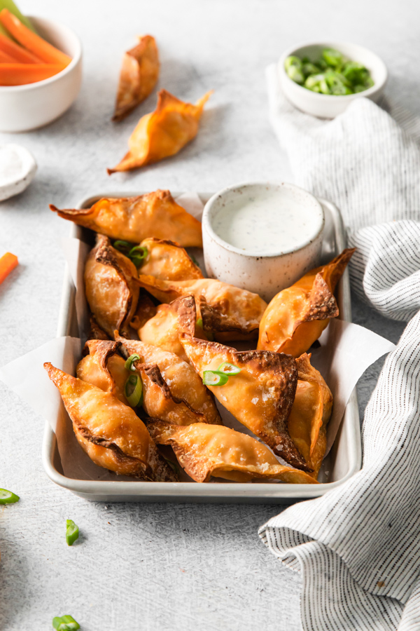 Air Fryer Buffalo Chicken Wontons topped with green onions. 