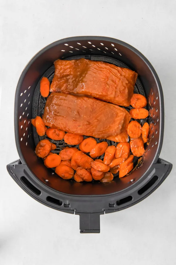Uncooked Air Fryer Miso Salmon in the air fryer basket.