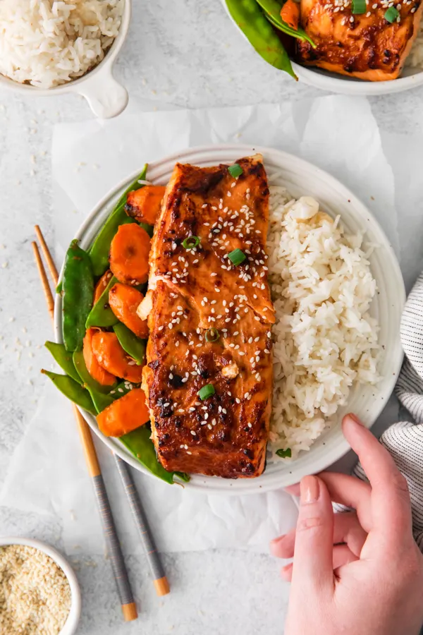 Air Fryer Miso Salmon on a plate with veggies and rice. 