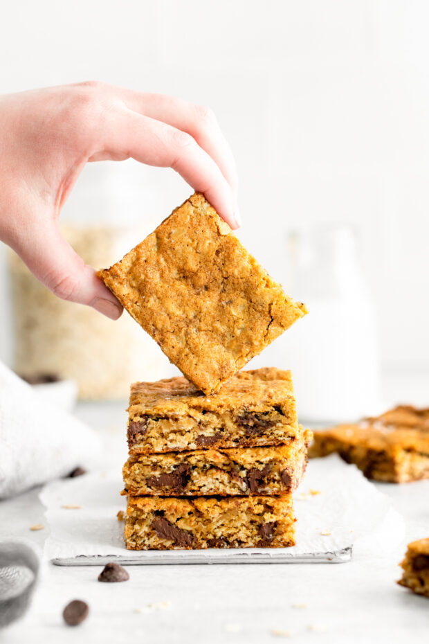 Chocolate Chunk Oatmeal Cookie Bars stacked on top of each other. 