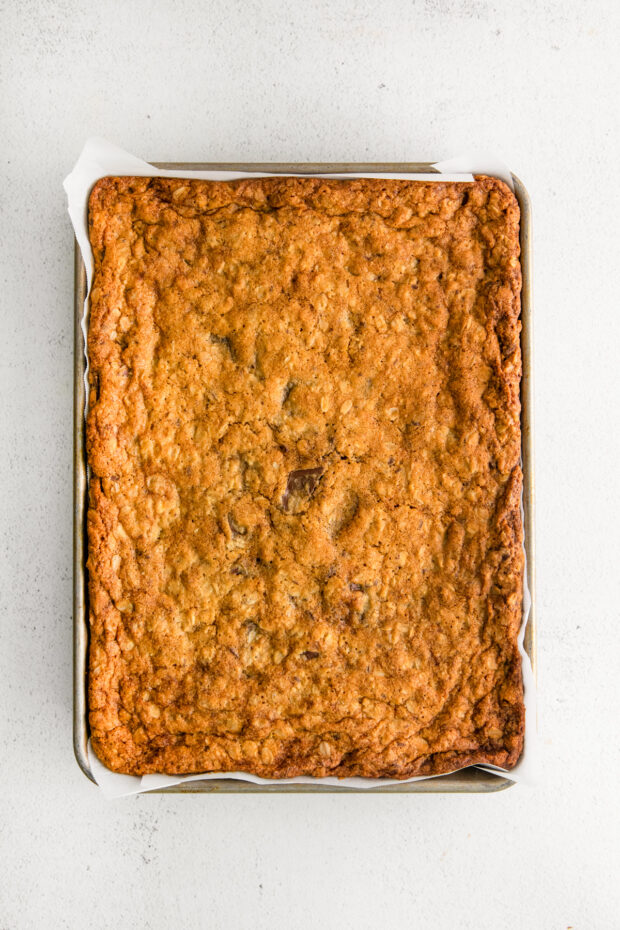 Cooked Chocolate Chunk Oatmeal Cookie Bars in a quarter sheet pan. 