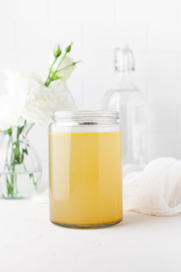 Instant Pot Chicken Stock in a glass jar. 