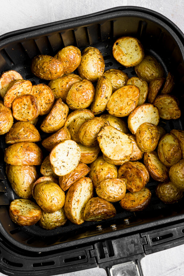 Air Fryer Roasted Potatoes in the air fryer metal basket. 