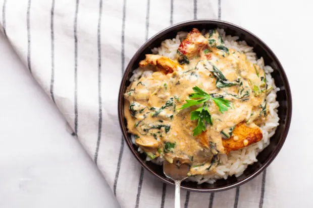 Creamy Tuscan Chicken sprinkled with basil. 