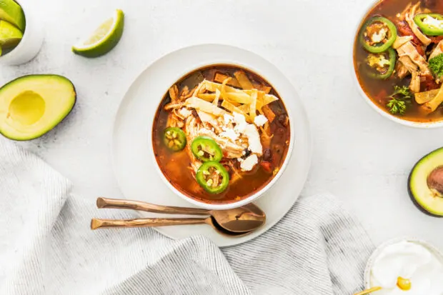 Instant Pot Chicken Tortilla Soup on a white table. 