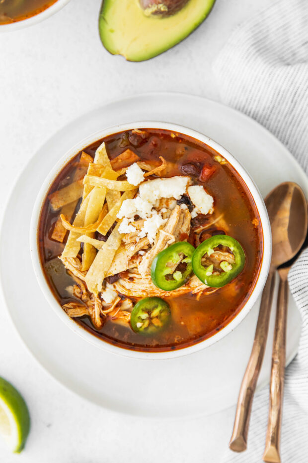 Instant Pot Chicken Tortilla Soup served with cheese and tortilla strips. 
