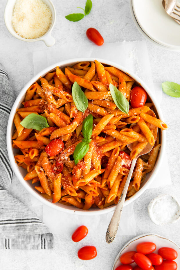 Penne Arrabbiata in a serving bowl with a serving spoon. 