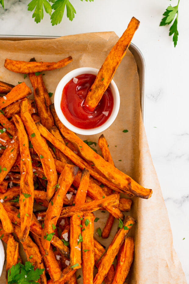 Sweet Potato Fries dipped into ketchup. 