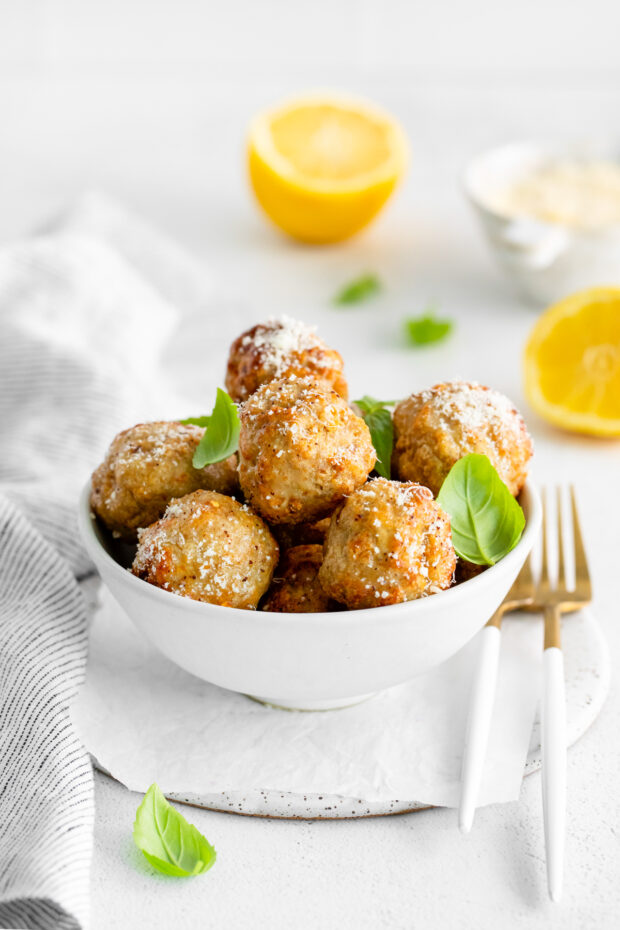 Air Fryer Chicken Meatballs sprinkled with parmesan cheese. 