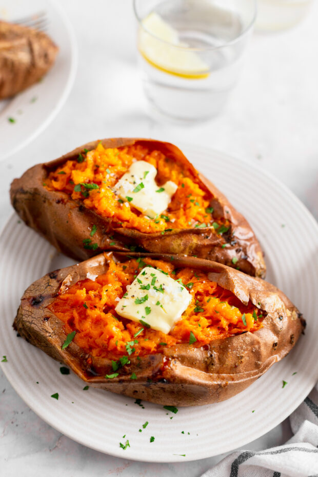 Baked Sweet Potatoes on a plate with butter. 