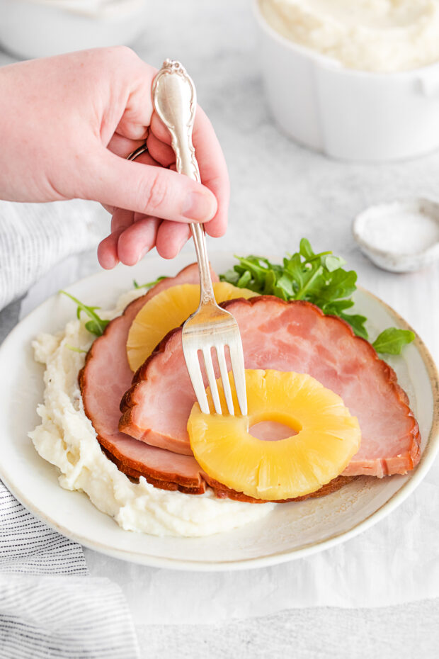 A fork taking a bite of 3-Ingredient Instant Pot Ham. 