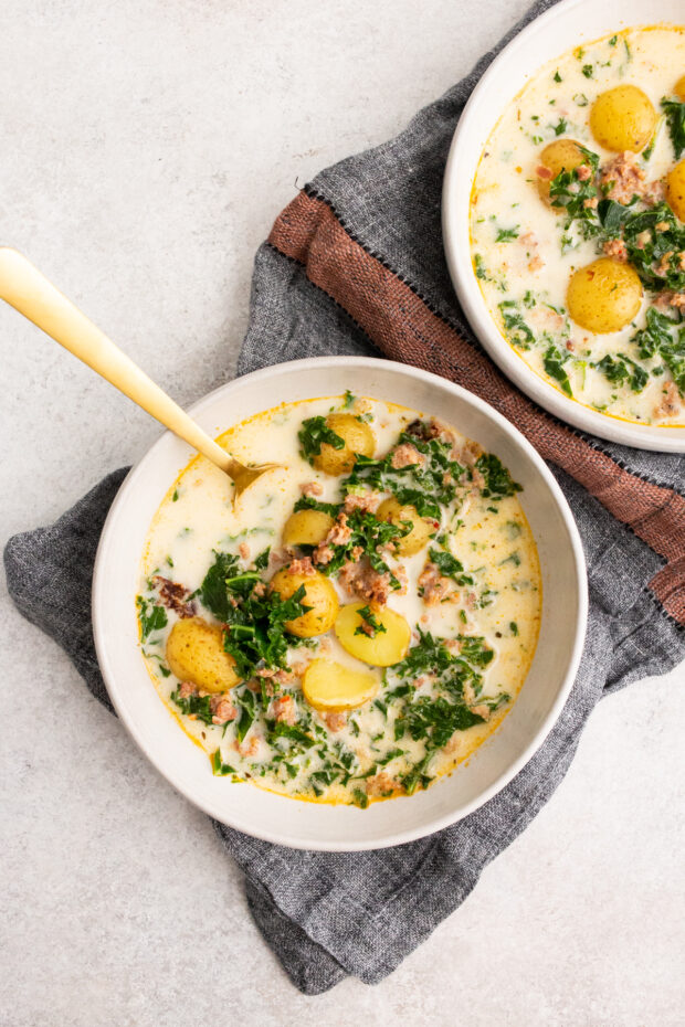 Instant Pot Zuppa Toscana Soup in a bowl with a spoon. 