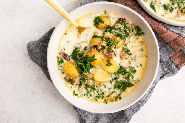 Instant Pot Zuppa Toscana Soup served with gold spoon. 