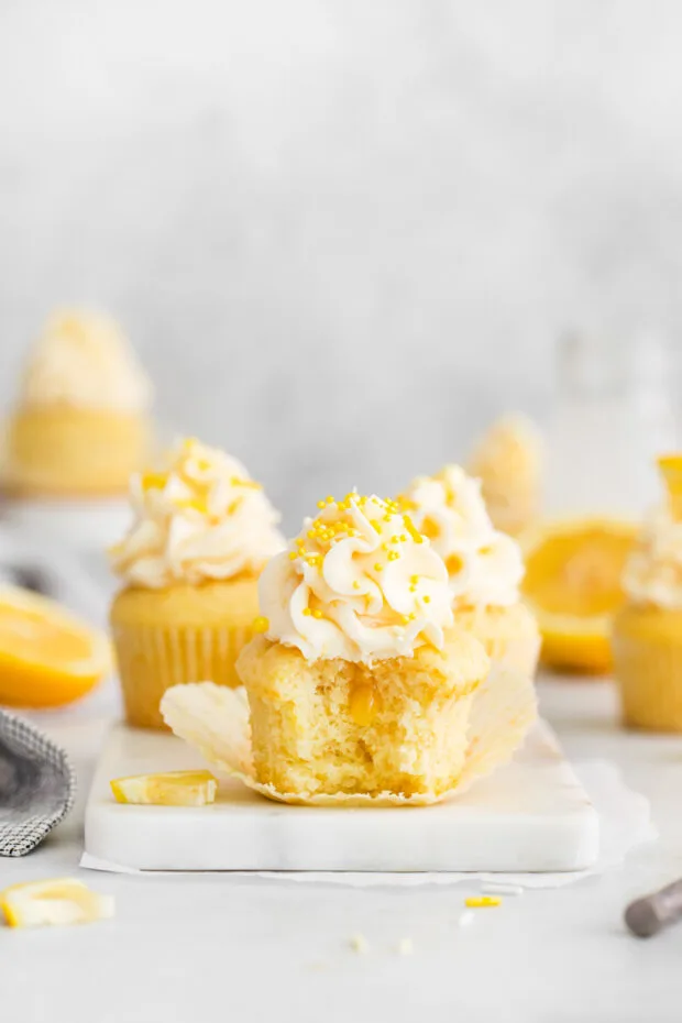 Lemon Curd Cupcakes cut in half showing lemon curd center. 