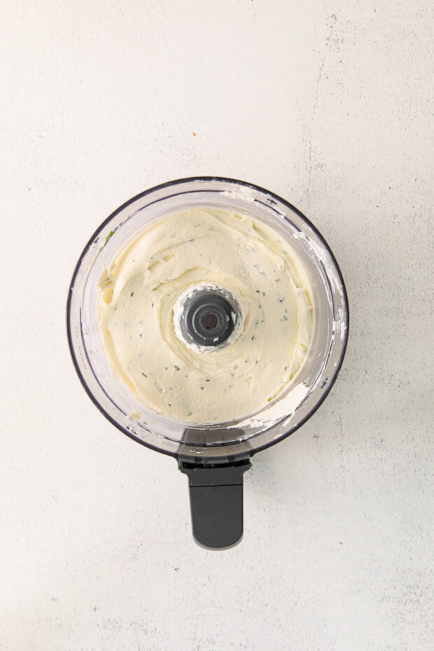 Whipped feta with herbs in a food processor. 