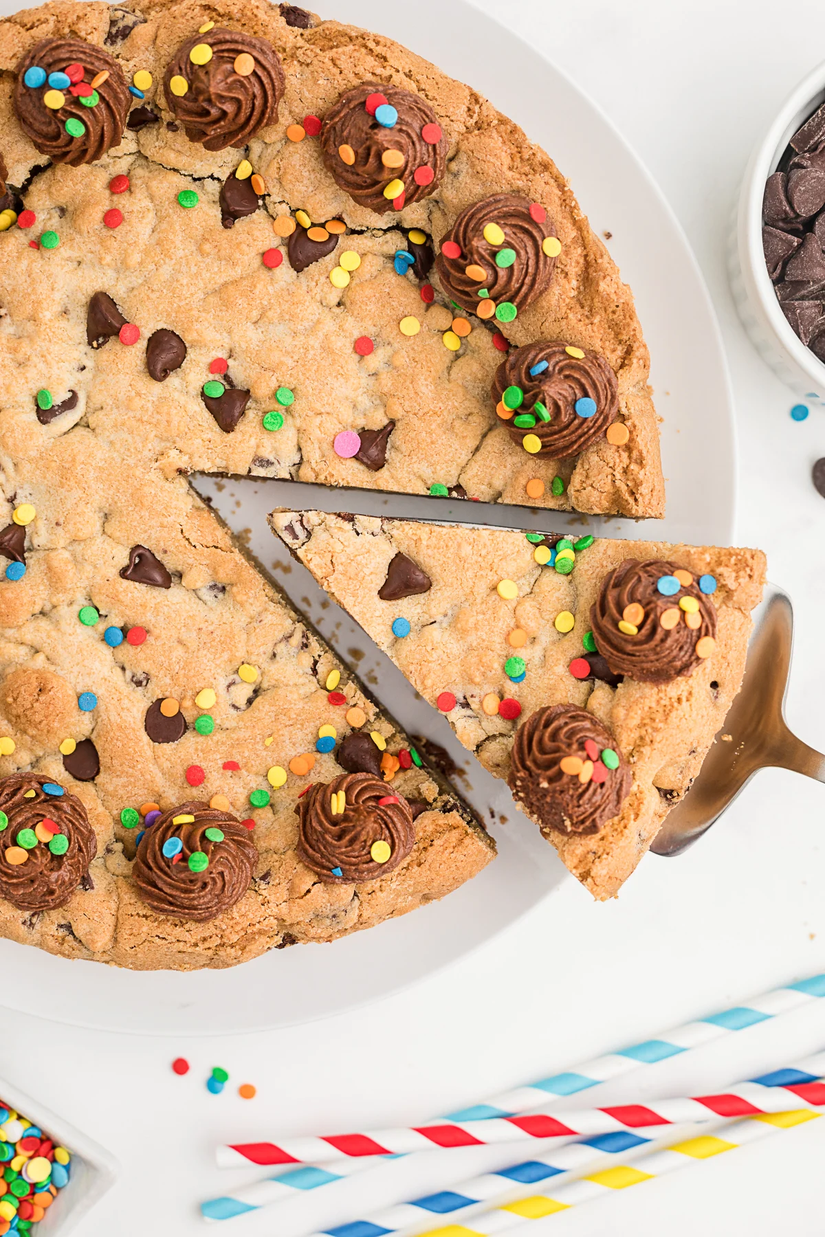 Removing a slice of Chocolate Chip Cookie Cake. 