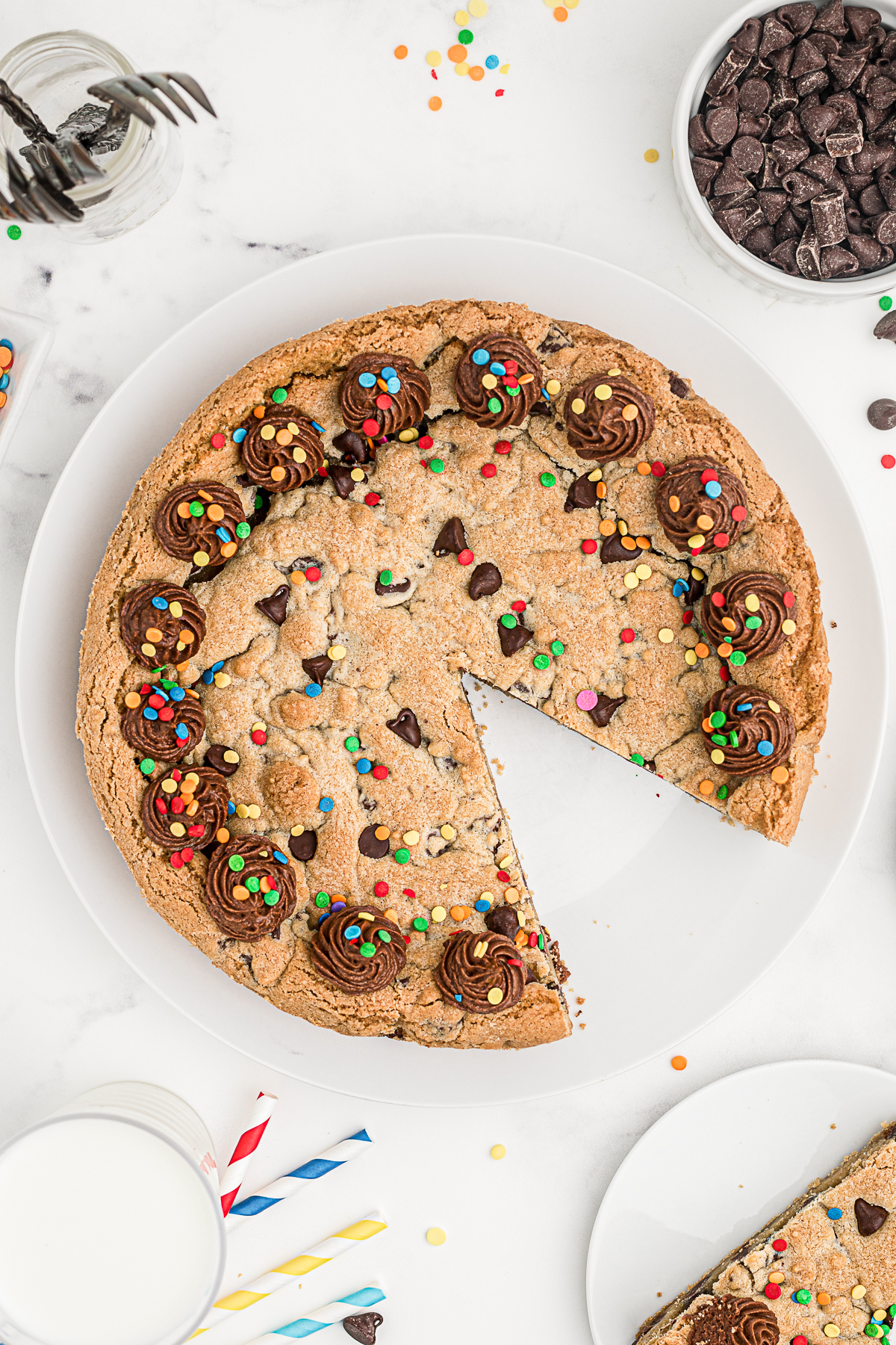 Chocolate Chip Cookie Cake with a sliced take out. 