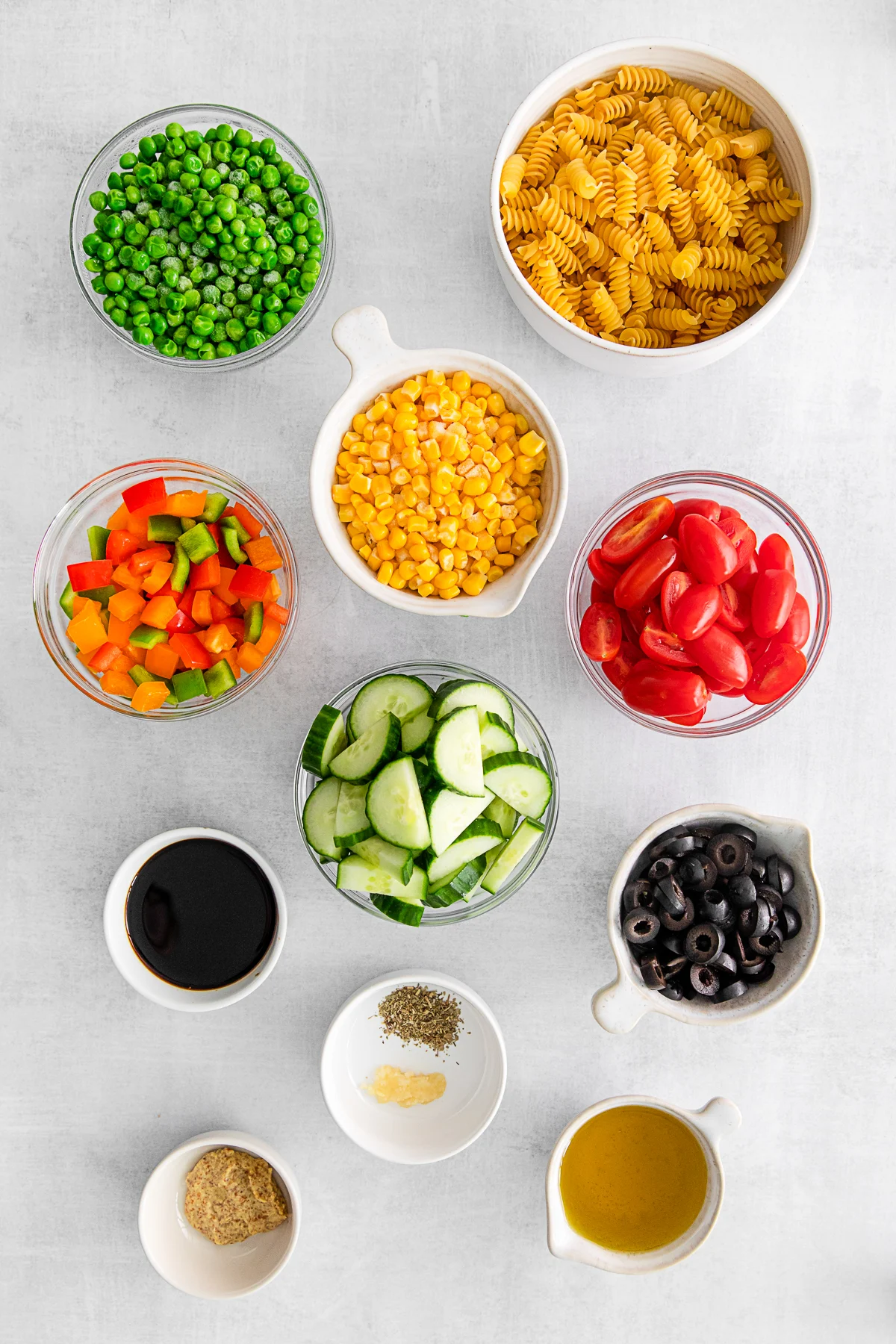 Ingredients to make Summer Pasta Salad on a table. 