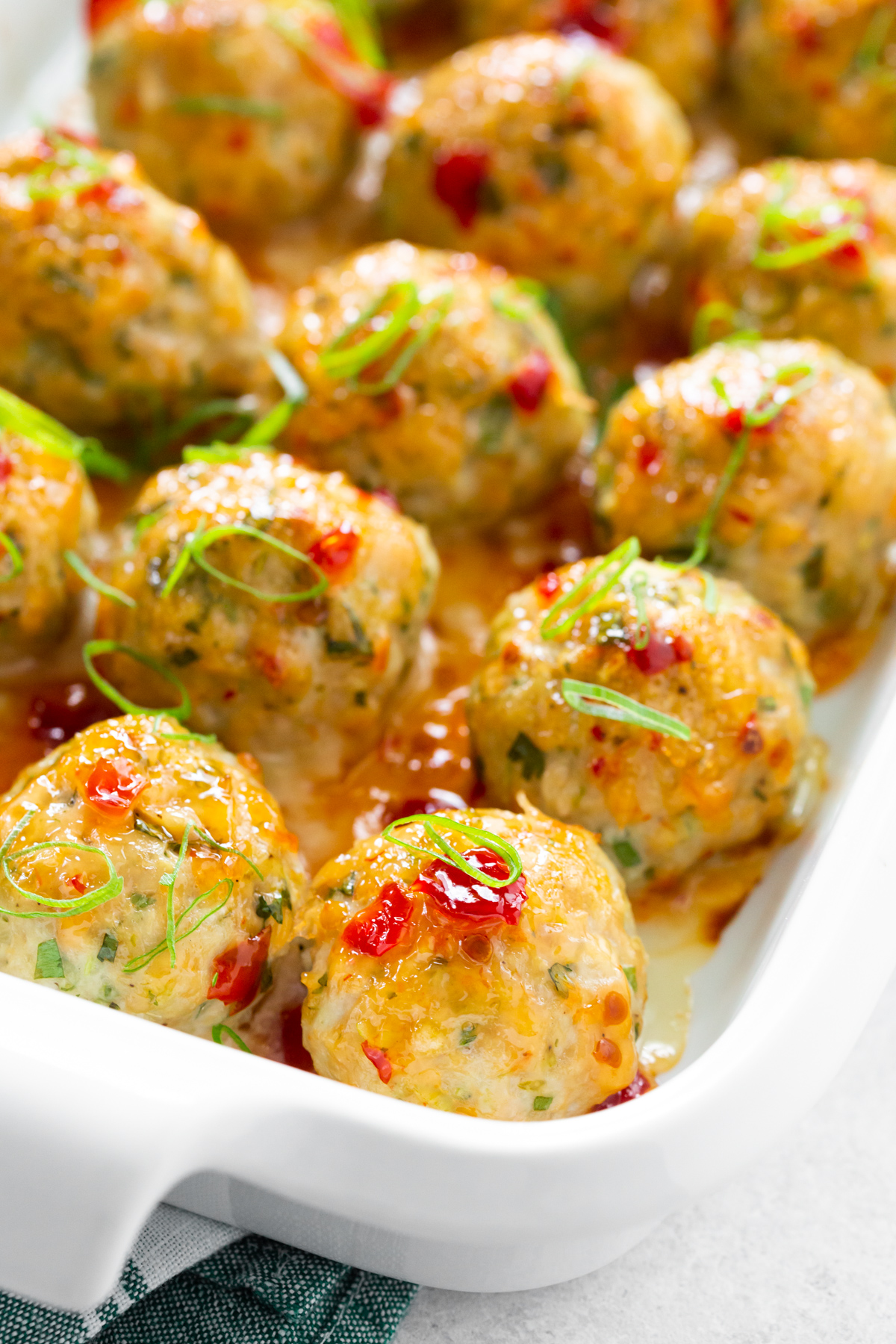 Easy Thai Baked Chicken Meatballs garnished with green onion. 