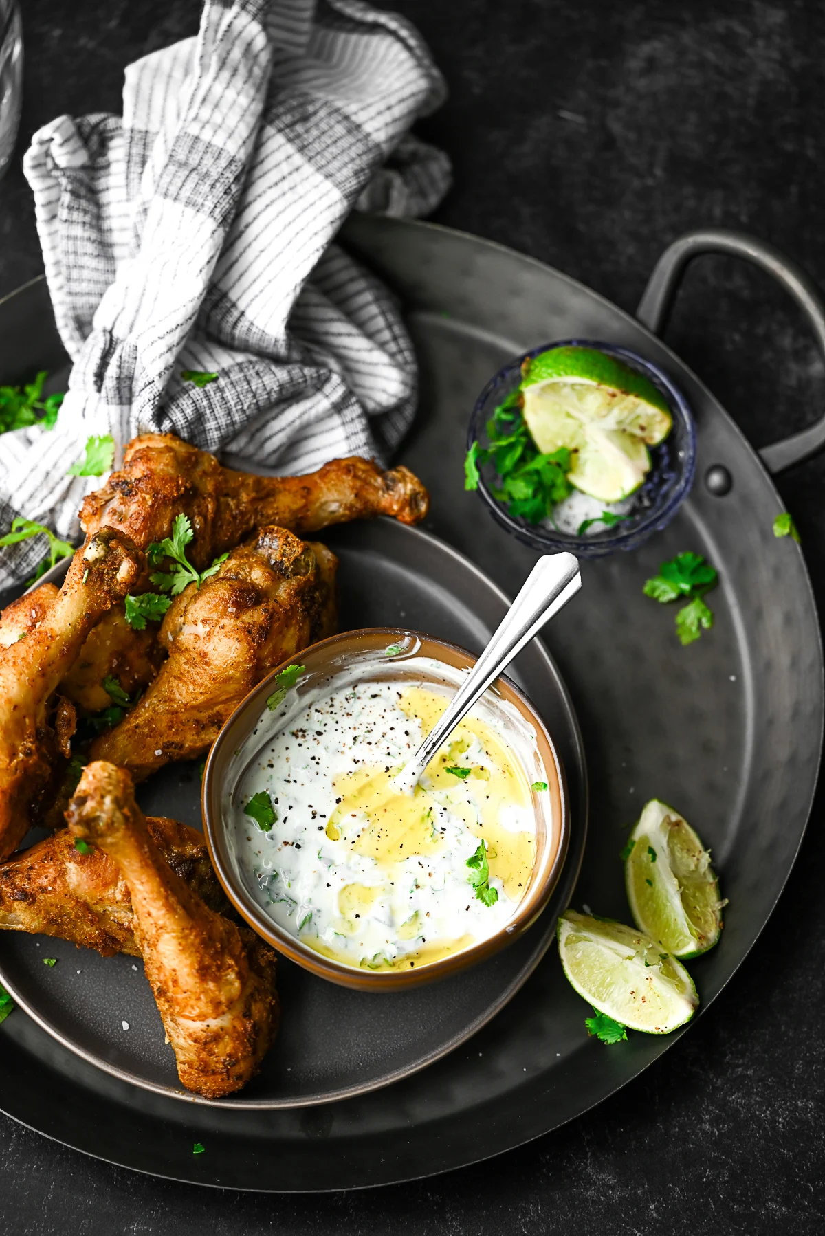 Air Fryer Chicken Legs served with a cilantro lime dipping sauce. 