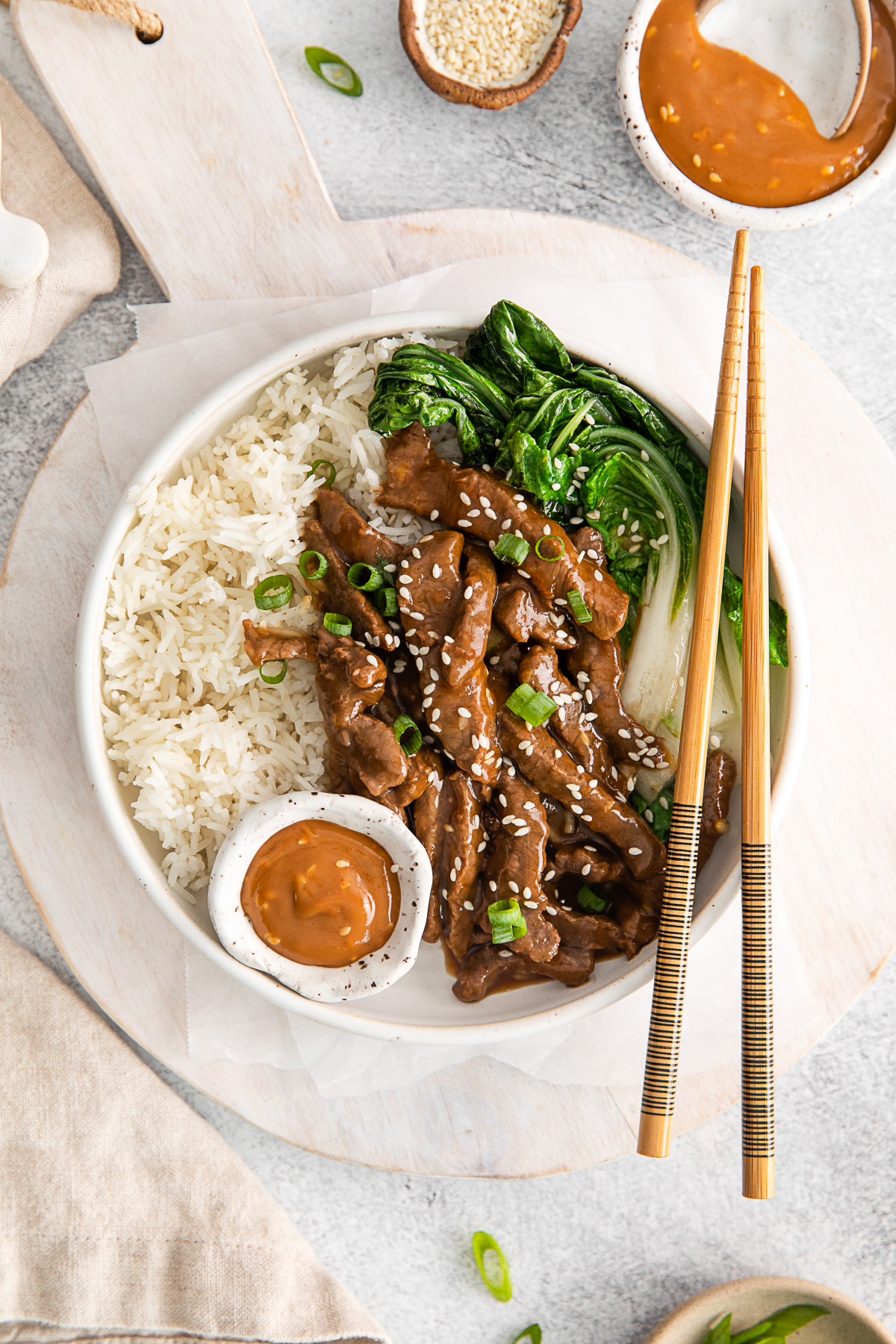Beef Bulgogi Rice Bowls served with bok choy and spicy tahini sauce. 
