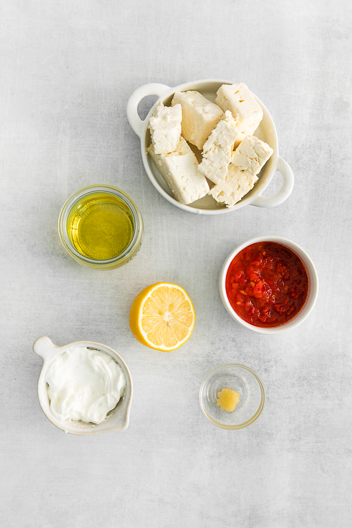 ingredients to make Harissa Whipped Feta on a table. 