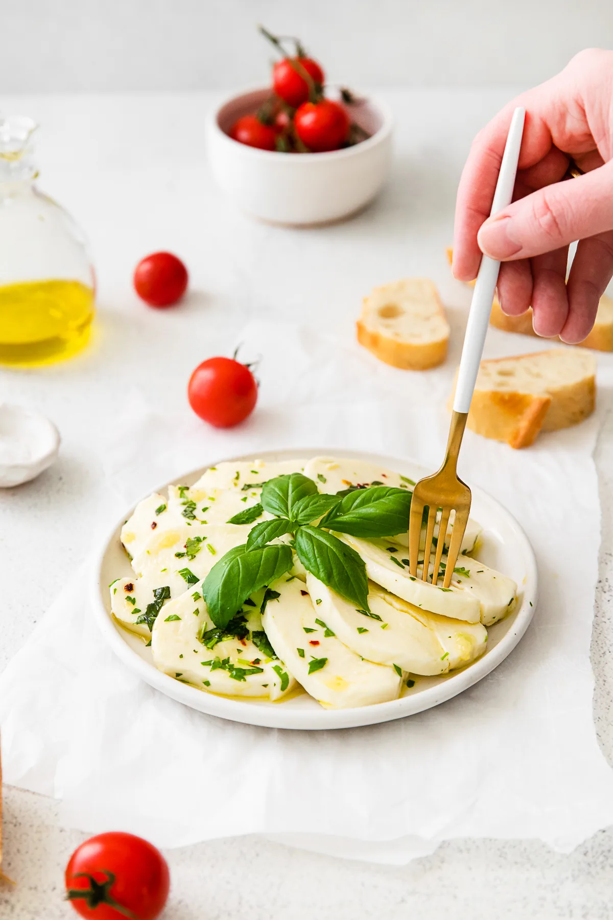 Marinated Mozzarella served with bread and tomatoes. 