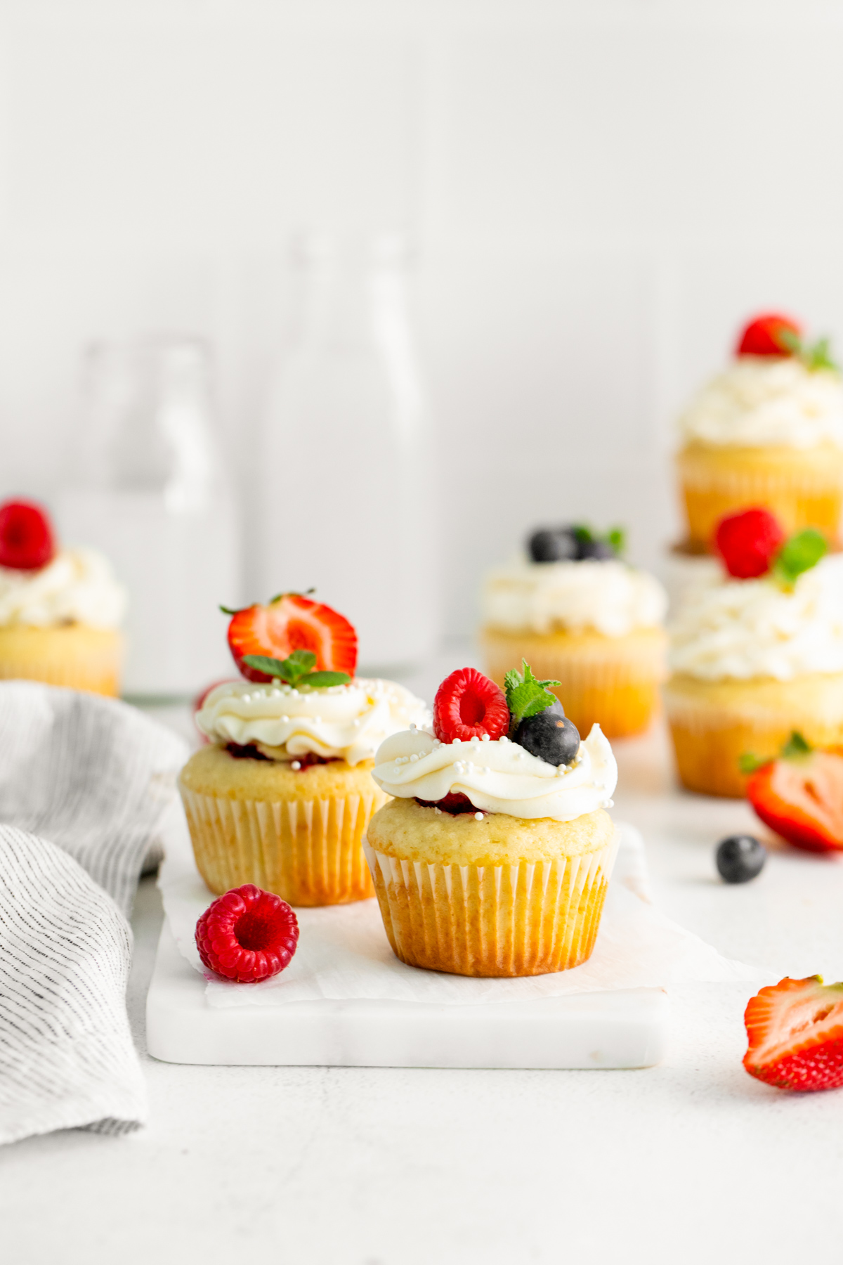 Mascarpone Berry Cupcakes on a white table. 