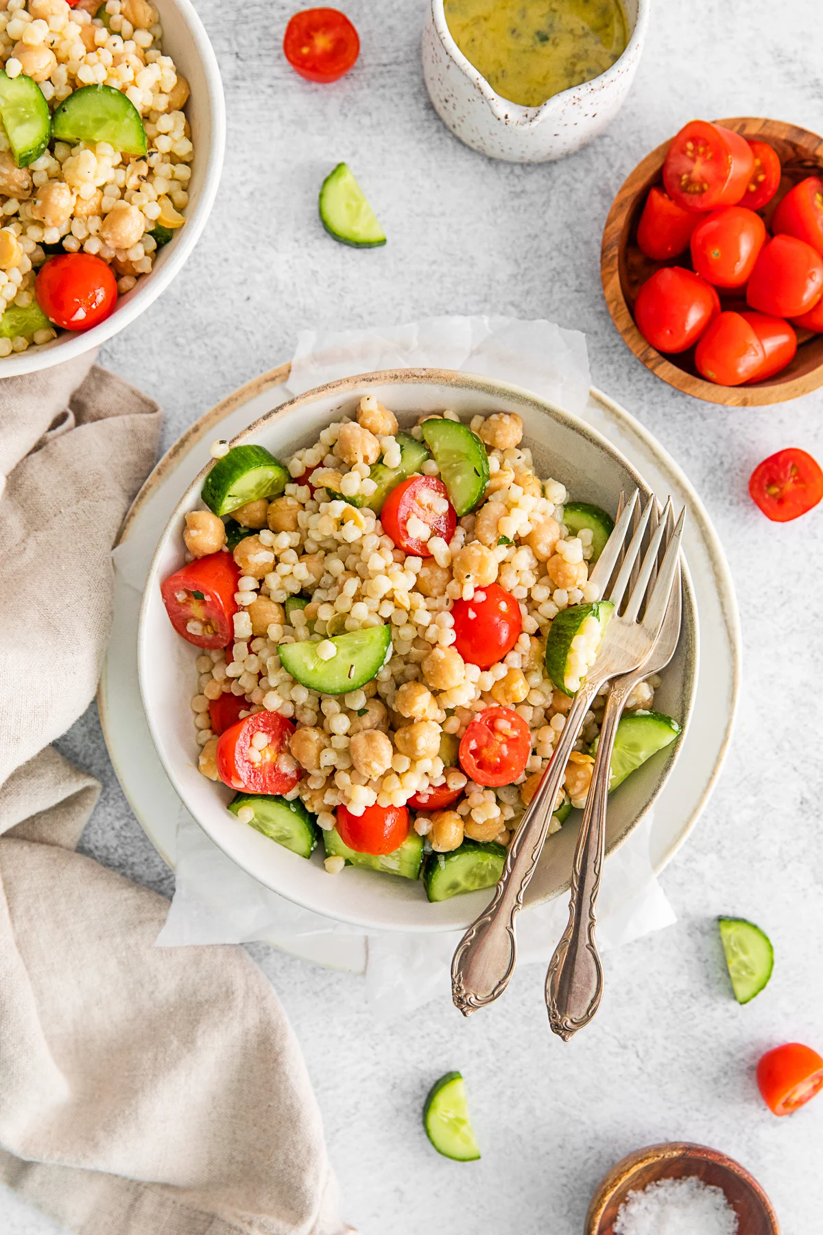 Mediterranean Couscous Salad in a bowl with a fork. 